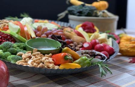 Harvest Board arranged with fresh vegetables, nuts, fruit and dips.