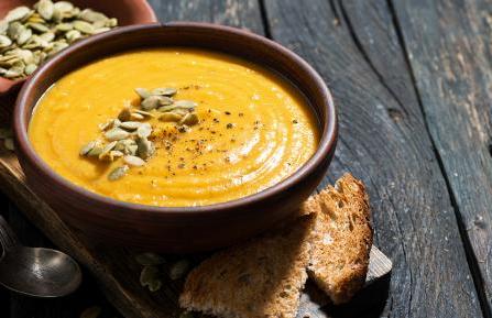 Bowl of pumpkin soup with pumpkin seeds